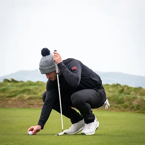 Man picking up golf ball